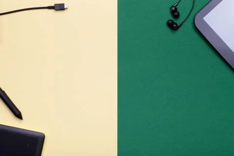 Graphic Tablet and Digital Tablet on Yellow and Green Background Stock Photos