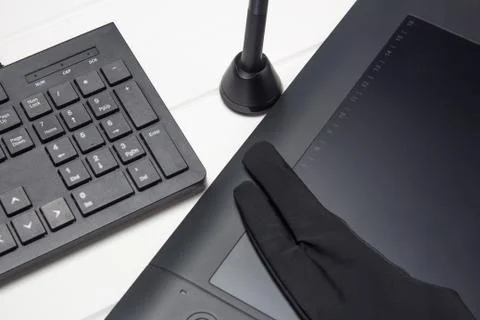 Graphic tablet, digital tablet and special pen, glove and keyboard on a white 写真素材