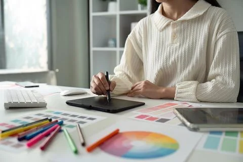 Graphic UI designer work on computer laptop and with graphic drawing pen after Stock Photos