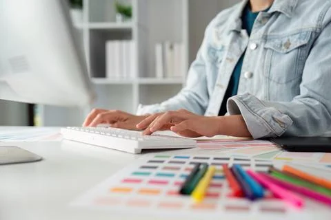 Graphic UI designer work on computer laptop and with graphic, working after Stock Photos