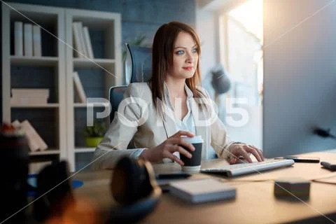 .Graphic woman designer at work working on computer for new project and drink Stock Photos