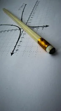 Graphical representation of math functions and a pencil Foto stock
