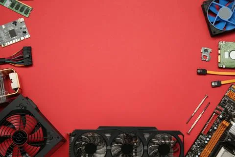 Graphics card and other computer hardware on red background, flat lay. Spac.. Stock Photos