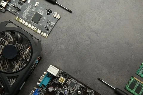 Graphics card and other computer hardware on grey textured table, flat lay... Stock Photos