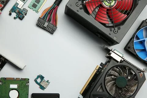 Graphics card and other computer hardware on light background, flat lay. Sp.. Stock Photos