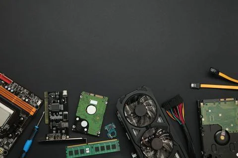 Graphics card and other computer hardware on black background, flat lay. Sp.. Stock Photos