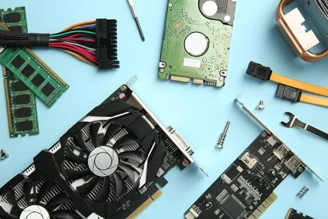 Graphics card and other computer hardware on light blue background, flat lay Foto stock