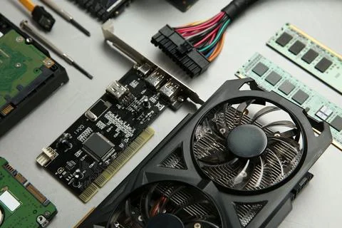 Graphics card and other computer hardware on gray textured background, abov.. Stockfoto's