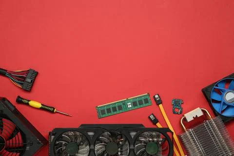 Graphics card and other computer hardware on red background, flat lay. Spac.. Stock Photos