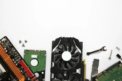 Graphics card and other computer hardware on white background, flat lay. Sp.. Stock Photos