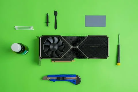 Graphics card service composition. Tools are arranged on the table around the Stock Photos