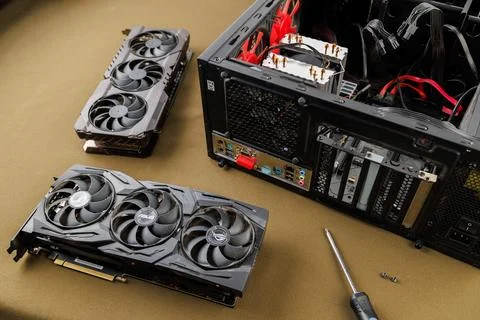 Graphics card upgrading concept, two gaming graphics cards near desktop Stock Photos