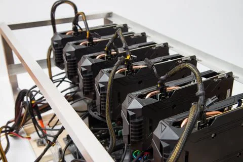 Graphics cards standing in a row in home mining farm. Close-up shot Stock Photos