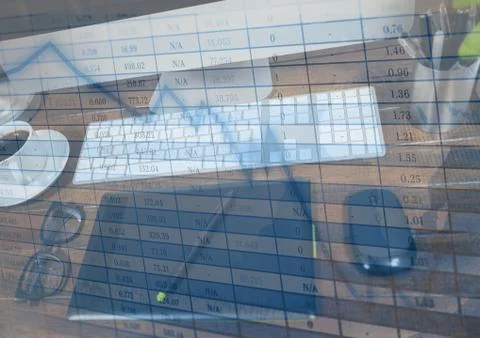 Graphics tablet at computer and blue graph overlay Stock Photos