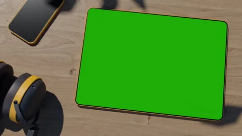 The graphics tablet is lying on a wooden table, the video has a green screen Stock Footage 260940165