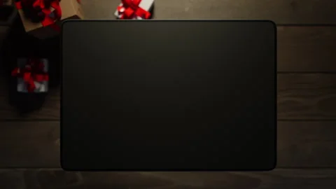 A graphics tablet rises above the table, displaying information. Video stock 260983901