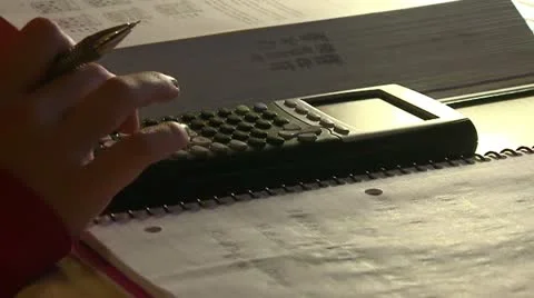 Graphing calculator being used for Math homework Stock Footage 12193036