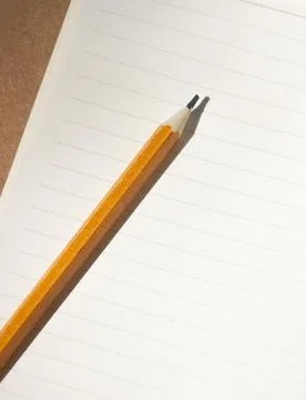 Graphite pencil on a blank sheet of paper in a ruler Stock Photos