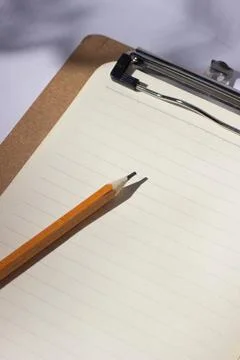 Graphite pencil on a blank sheet of paper in a ruler Stock Photos