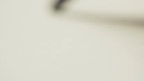 Graphite pencil draws a straight line on a white background paper, macro shot Stock Footage 134648981