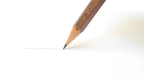 Graphite pencil draws a straight line on a white paper background, close up shot Video stock 276206095