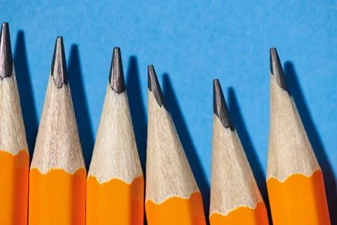 Graphite pencils on a blue background macro photo, school and office supplies Stock Photos