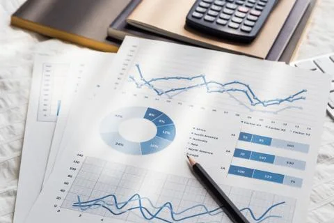 Graphs analysis documents work at home on bed. Stock Photos