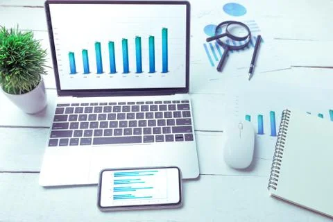 Graphs and charts elements on laptop computer screen  and on phone screen sta Stock Photos