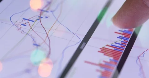 Graphs and data sheets on a digital touchscreen tablet device Video stock 85288279