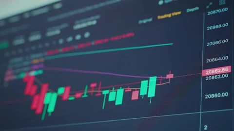 The graphs of the cryptocurrency exchange rate are displayed on the monitor. Stock Footage 231154250