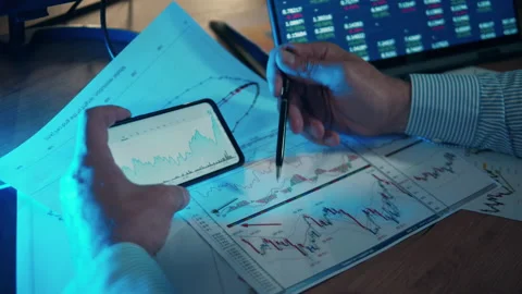 Graphs of stock prices are being compared and analyzed Stock Footage 169568915