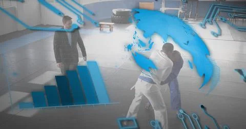 Grappling martial artists practicing holds on padded mats at gym, with gis, d Stock Photos