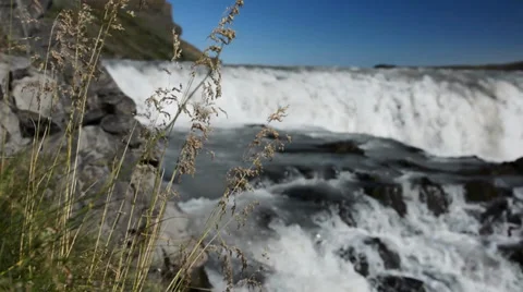 Grass and rocks in front of blurred Gullfoss waterfall, Iceland Stock Footage 33795247