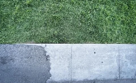 Grass and sidewalk Stock Photos