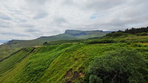 Grass covered cliffs and distant mountains in the Isle of Skye, Scotland on a Stock Footage 342184463