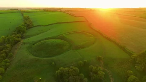 Grass covered mounds marking the remains of a medieval castle in rural England Stock Footage 346604764
