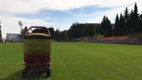 Grass-cutter cuts green grass on football field Stock Footage 95013734