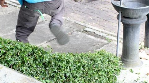 The grass cutter is cutting the grass using a lawn mower Stock Footage 231828309
