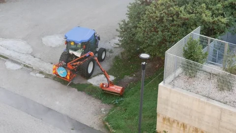 Grass cutting with mobile brushcutter 4k Stock Footage 228884042
