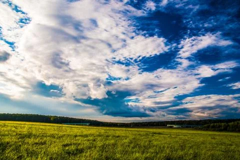 Grass field and dramatic sky at sunset 스톡 사진