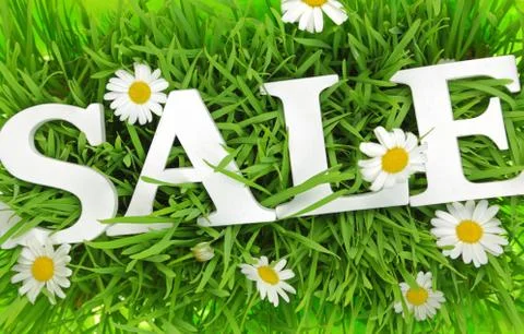Grass with flowers and white text Sale on it Stock Photos