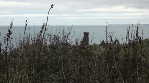 Grass in foreground of a tower and ruin. Ocean in the background, Peel Castle Stock Footage 43181773