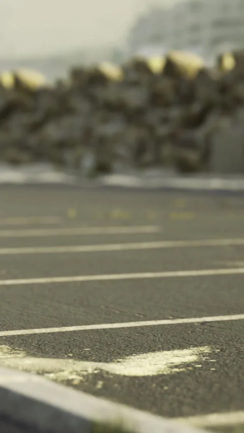 Grass grows in cracks of an empty parking lot in a city Stock-Footage 336987202
