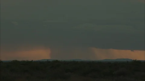 Grass landscape with sun setting behind clouds Video stock 95601563