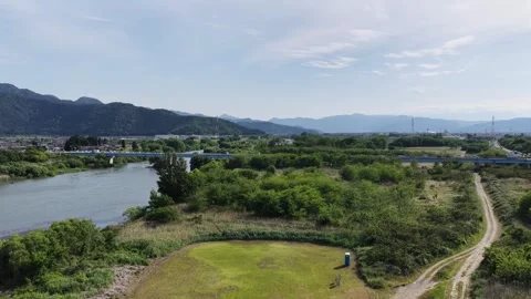 Grassland River Bridge and Mountains Aerial View in Nagano Stock Footage 336617044