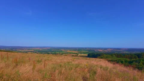 Grassy hill slope under blue sky with light clouds in Ireland Stock Footage 340435594