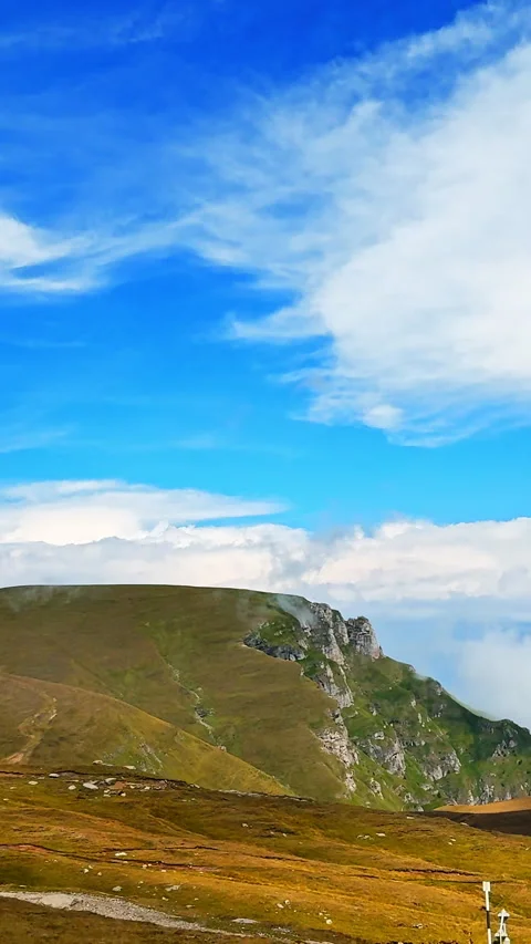 Grassy mountain ridge ending in steep limestone cliffs. Vertical video. Stock Footage 333147633