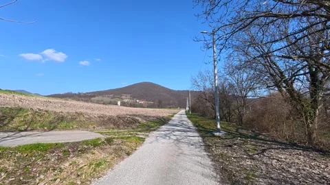 Grassy path winds through quiet countryside. Balkan, Eastern Europe, POV Video stock 331455133