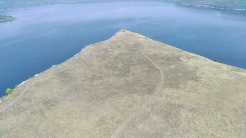 Grassy Ridge Meets Large Calm Lake. Stock Footage 313953765