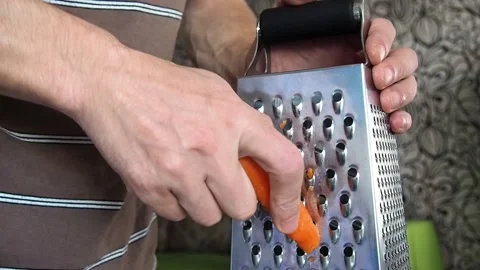 Grate carrot on a grater. Stock Footage 97381605
